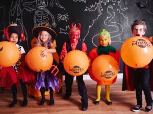 Friends swapping eco-friendly Halloween costumes at a costume swap party